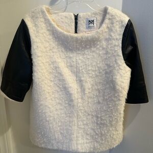 Milly! Wool top with black calf leather long short sleeves. Zips ip the back.